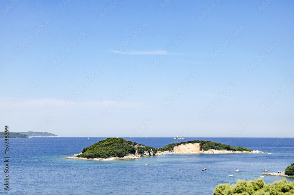 Beautiful Mediterranian island with white beach seen from the sea