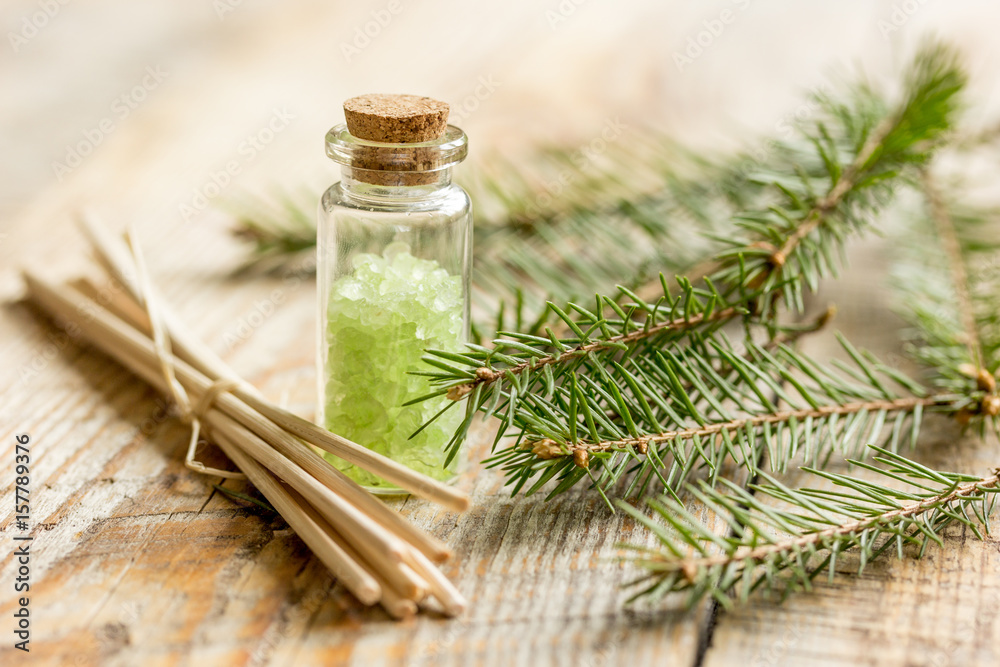 fir branches and spruce bath salt on wooden table background fir branches and spruce bath salt on wooden table background
