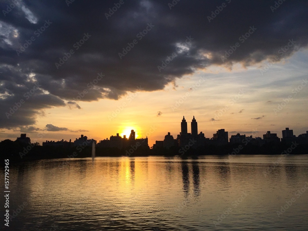 Jacqueline Kennedy Onassis Reservoir lake and buildings in Manhattan with sunset