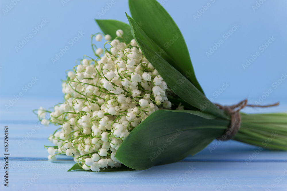Obraz premium Lily of the valley on wooden background. Lily of the valley bouquet