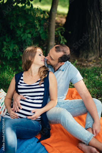 Man and pregnant woman, in an amorous couple in the park © ShevarevAlex