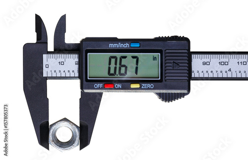 The digital caliper measures the diameter of the old nut. Objects isolated on white background.