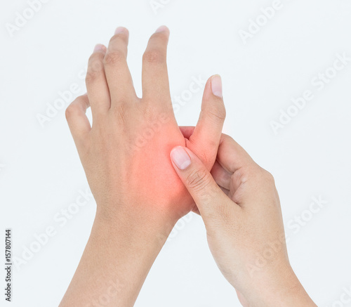 Young woman massaging her painful hand, suffering from hand pain isolated on a white background