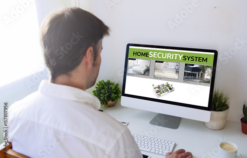 man viewing security cams on computer