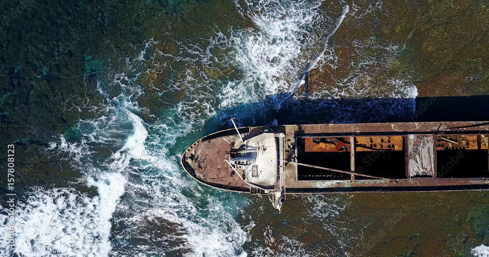 Beautiful seascape with old big, broken, rusty boat near the coast of Peyia, Cyprus. Ship graveyard. Famous landmark in the Mediterranean sea.