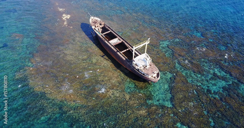 Beautiful seascape with old big, broken, rusty boat near the coast of Peyia, Cyprus. Ship graveyard. Famous landmark in the Mediterranean sea. © Kateryna