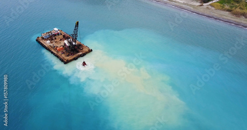 Barge lifts the sand using a ladle from the bottom of the sea. Landscape shot of drone. Mediterranean Sea. Cyprus