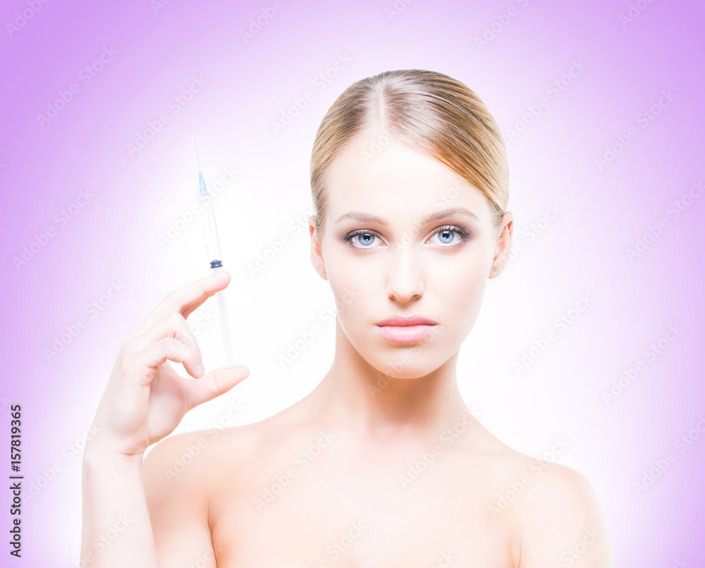 Young, beautiful and healthy woman having skin injections over magenta background. Plastic surgery concept.