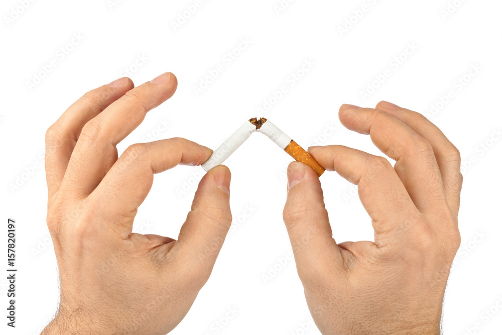 Broken cigarette in hands Broken cigarette in hands