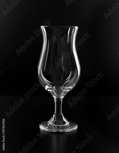 Classic cocktail empty hurricane glass isolated on black background