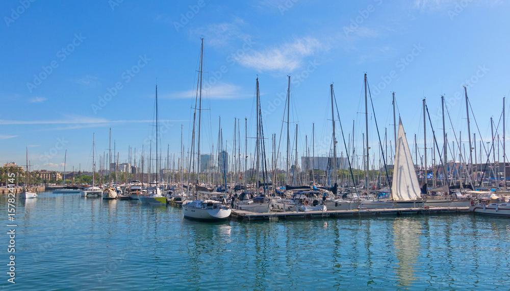 Sailboats moored in the port of barcelona, near the Ramblas and the monument of Columbus. Barcelona, Spain