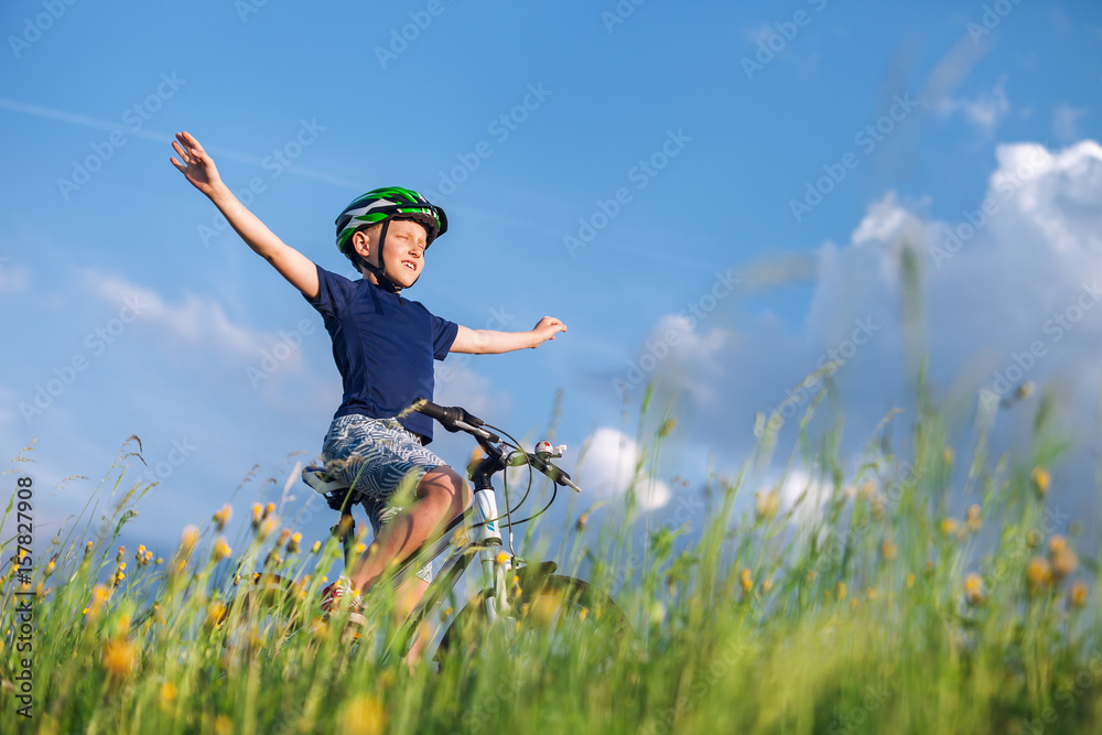 Happy boy ride a bicycle without hands and enjoy with sunlight Happy boy ride a bicycle without hands and enjoy with sunlight