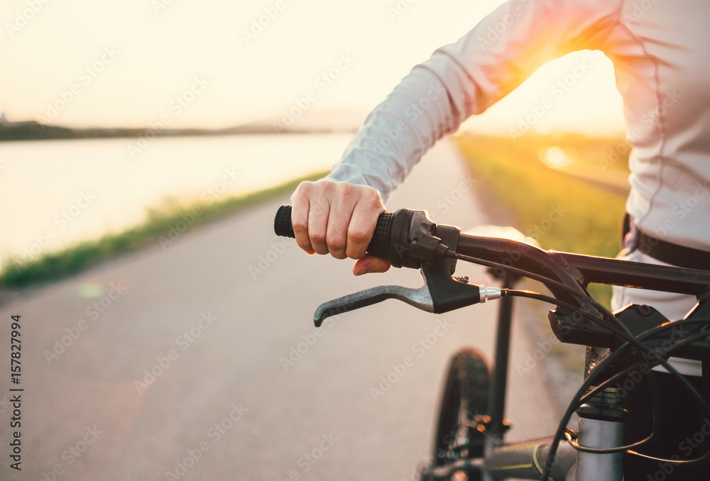 Close up woman hand on the bicycle handlebars Close up woman hand on the bicycle handlebars