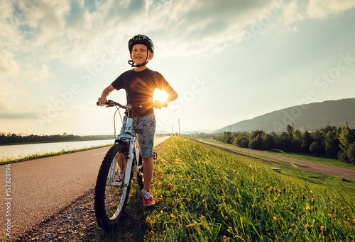 Smiling boy starts to ride a bicycle