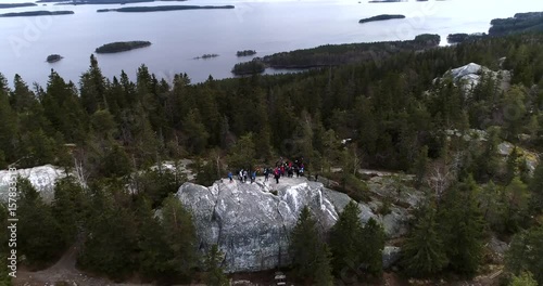 Koli, Cinema 4k aerial orbit view around people on akka-koli, on a summer day, in Koli national park, Lieksa, Karelia, Finland photo