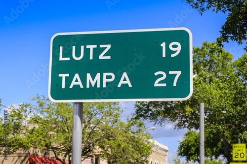 Green and white mile marker to Lutz and Tampa in SW Florida