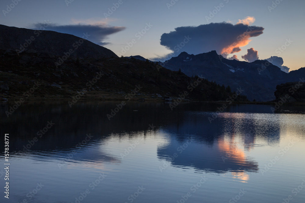 Reflection clouds on the Angeloga lake, Spluga valley, Lombardy, Italy