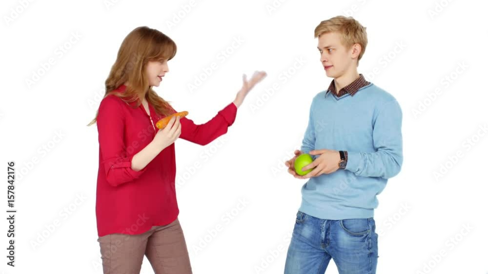 Crazy young vegeterians with fresh vegetables and fruits on a white background Crazy young vegeterians with fresh vegetables and fruits on a white background