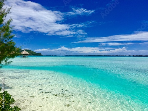 Beautiful turquoise lagoon of Bora Bora and the overwater bungalows of a luxury resort