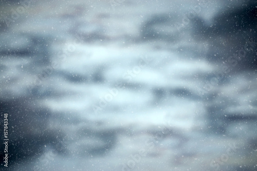 Abstract of water surface background with snow fall.