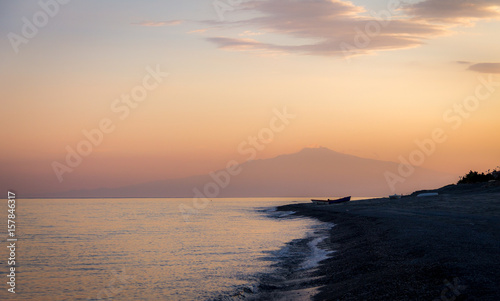 Sunset on a Mediterranean beach of Ionian Sea with Mount Etna Volcano on background - Bova Marina  Calabria  Italy