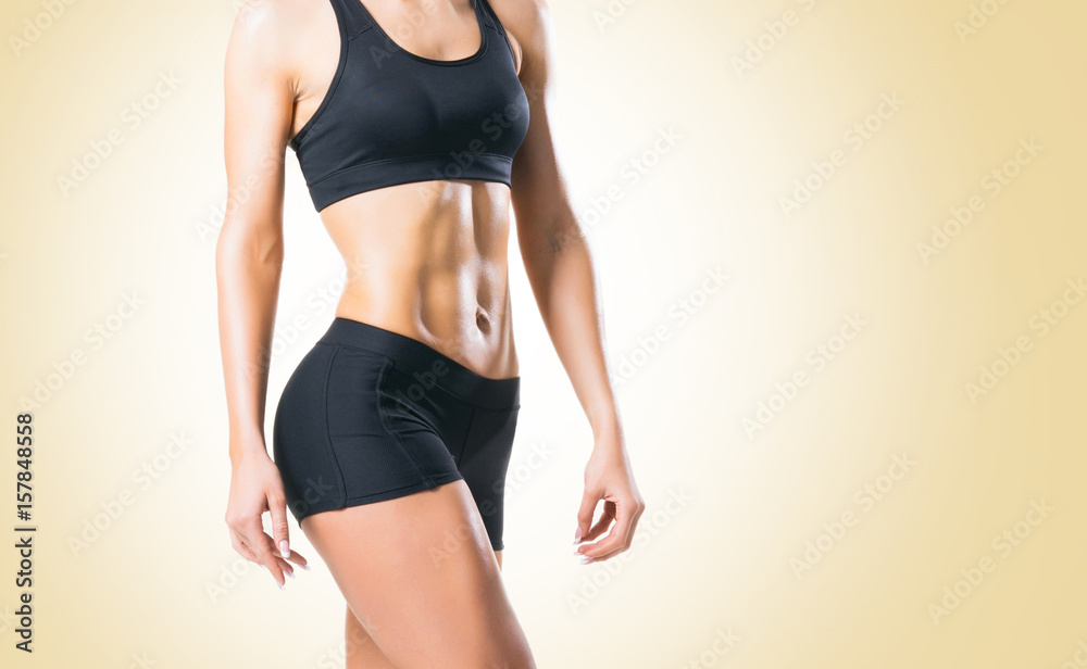 Fit, healthy and sporty woman in sportswear over yellow background. Fit, healthy and sporty woman in sportswear over yellow background.