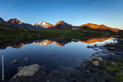 Sunset at Mount Disgrazia seen from a seasonal lake at  Scermendone Alp Raethian Alps  Valtellina  Lombardy  Italy Europe