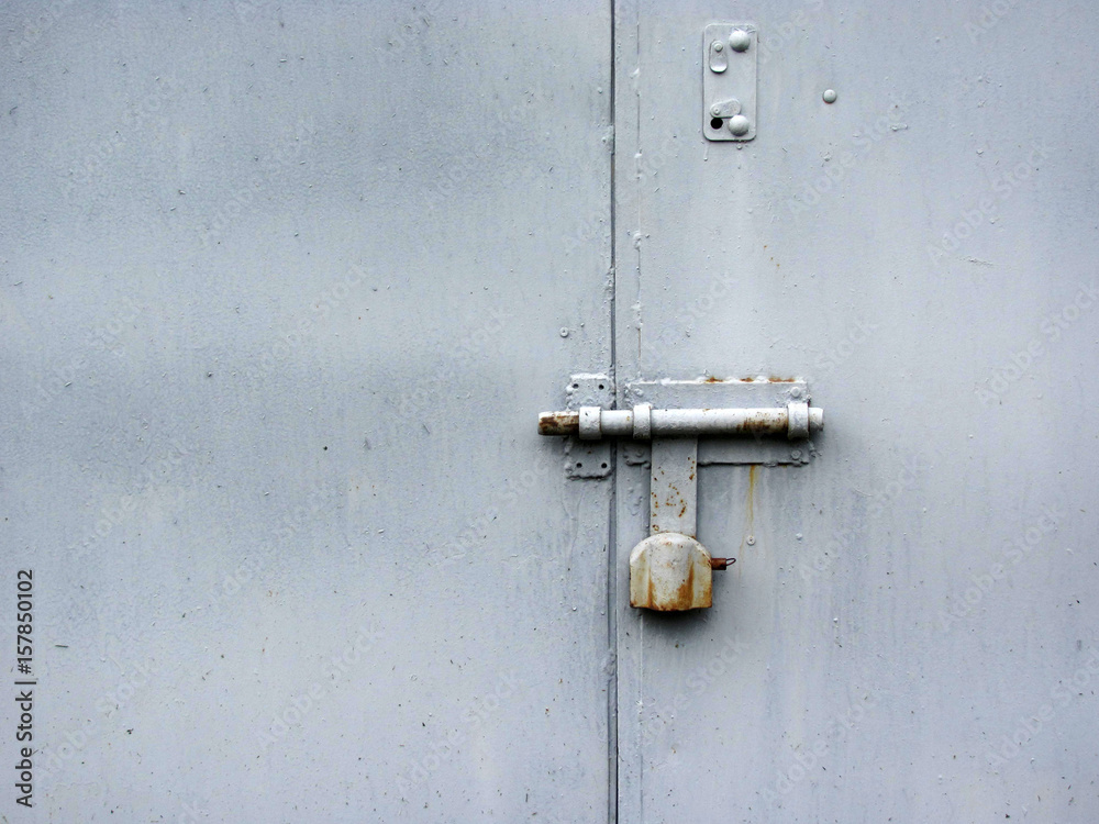 Gray metal door with lock, close-up