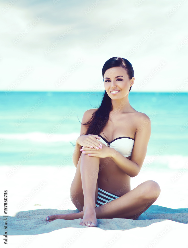 Young, beautiful and sexy woman relaxing on a summer beach. Traveling, vacation, concept. Young, beautiful and sexy woman relaxing on a summer beach. Traveling, vacation, concept.