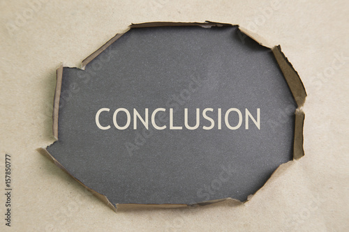 Fotografie The text conclusion appearing behind torn paper