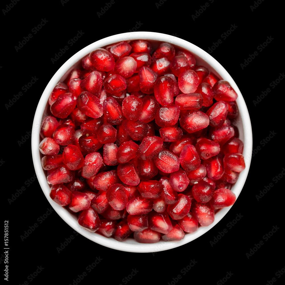 Grains Of Pomegranate In A White Bowl Isolated On Black Background. Close-Up. Top View. Grains Of Pomegranate In A White Bowl Isolated On Black Background. Close-Up. Top View.