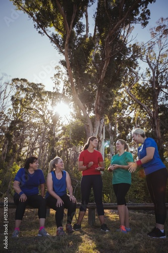 Group of fit women interacting with each other in the boot camp