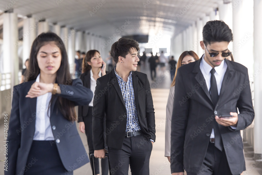 Quick briefing before meeting. young asian business people talking to each other while walking outdoors, 20-30 year old. Quick briefing before meeting. young asian business people talking to each other while walking outdoors, 20-30 year old.