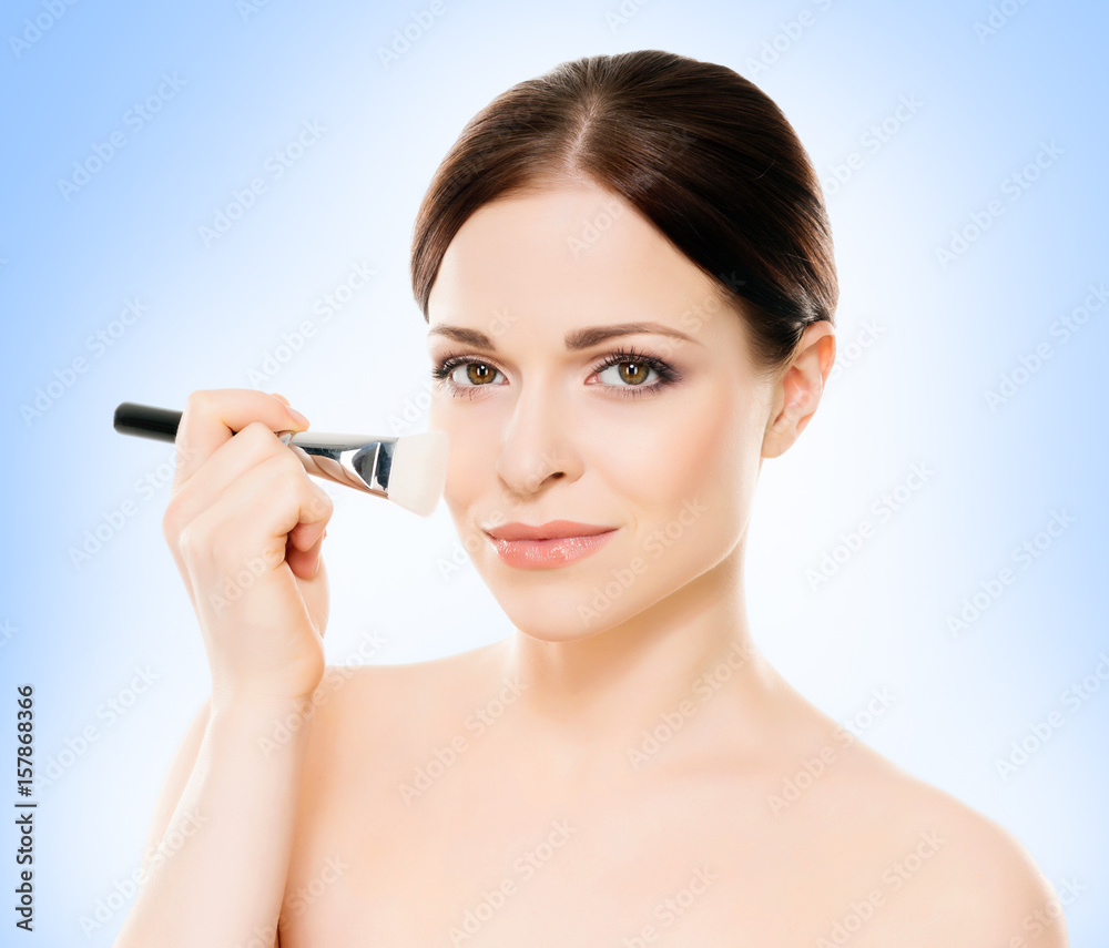 Portrait of young, beautiful and healthy woman: over blue background. Healthcare, spa, makeup and face lifting concept. Portrait of young, beautiful and healthy woman: over blue background. Healthcare, spa, makeup and face lifting concept.
