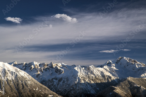 Clouds above snowy peaks and Mount Disgrazia in the background Olano Gerola Valley Valtellina Rhaetian Alps Lombardy Italy Europe