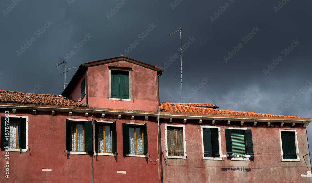 Threatening Clouds and red house