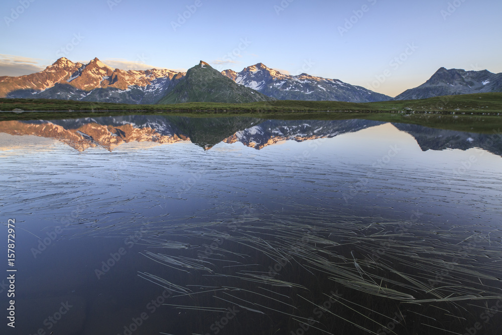 Mount Cardine and Peak TambÃ² are reflected in Lake Andossi at sunrise Chiavenna Valley Valtellina Lombardy Italy Europe