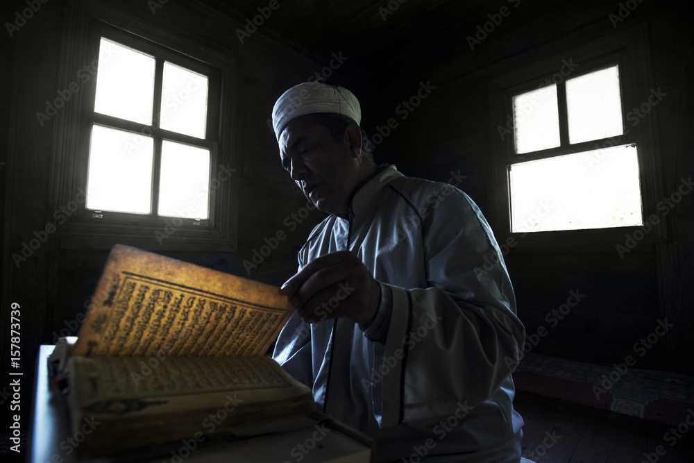 A Man reading al-Quran A Man reading al-Quran