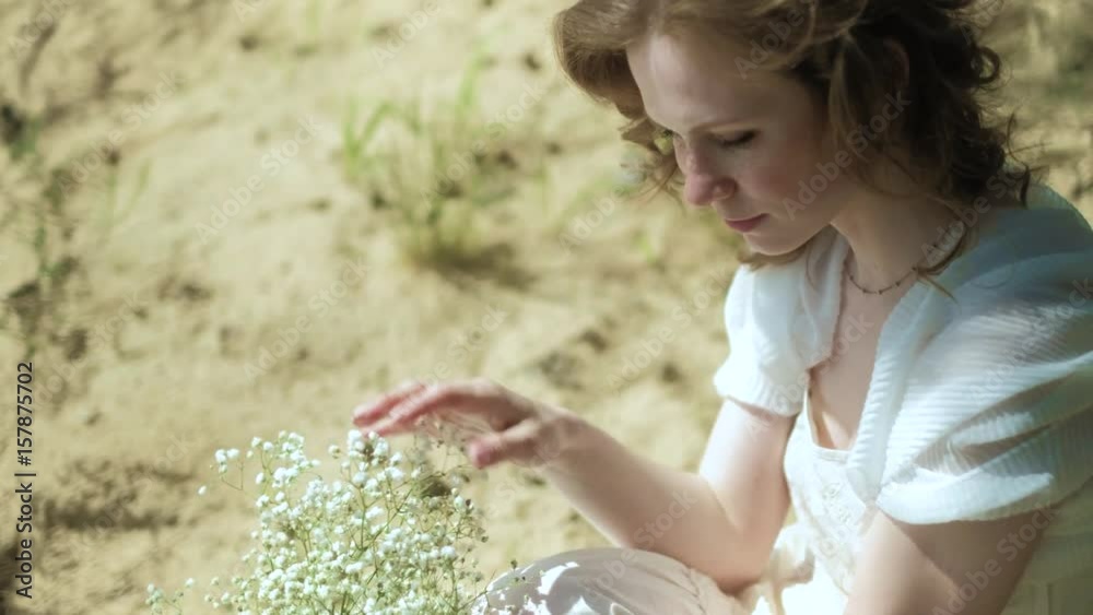 Beautiful woman in a white gown dress in the forest with flowers 4k Beautiful woman in a white gown dress in the forest with flowers 4k