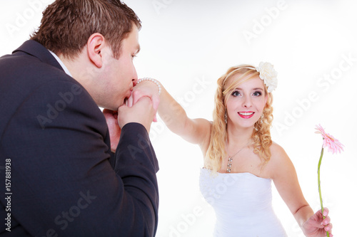 Happy groom and bride posing for marriage photo