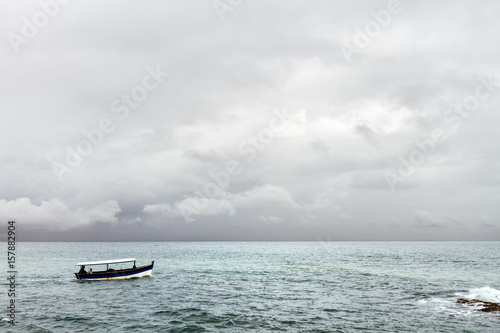 A speedboat sails near the rocks near Salvador, Brazil