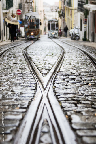 The steel rails on a rainy day with the typical trams leading to Bairro Alto district Lisbon Portugal Europe