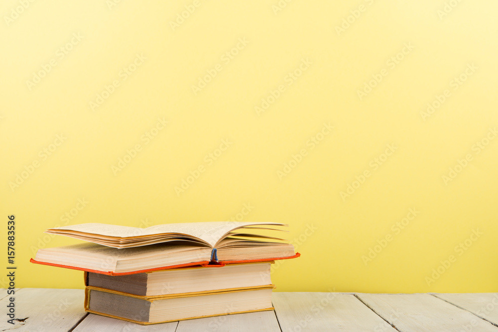 education and wisdom concept - open book on wooden table, color background education and wisdom concept - open book on wooden table, color background