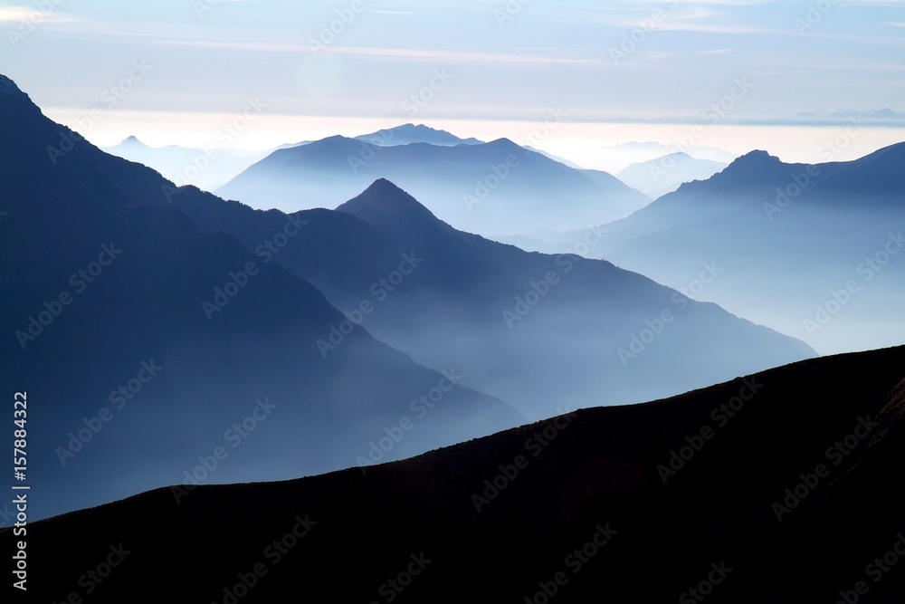 The ridges of the lake follow each other in the direction of the Po Valley with the mist to accentuate the vastness of the scenery. High Lario. Lake Como. Lombardy. Italy. Europe