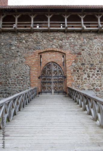 Wooden door in the castle and wooden bridge photo