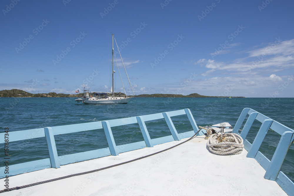 Obraz premium Sailboats and vessels in the turquoise waters of the Caribbean Sea Green Island Antigua and Barbuda Leeward Island West Indies