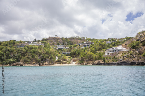 The turquoise Caribbean sea and a tourist resort seen from a boat tour Antigua and Barbuda Leeward Islands West Indies
