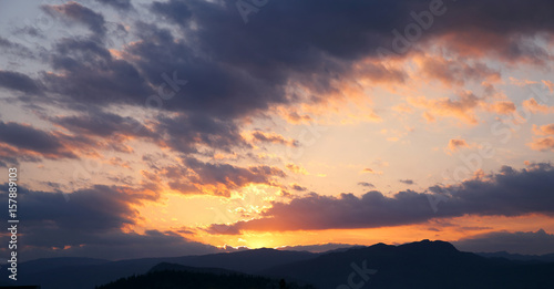 Sunset. Sky clouds background. Ridge Mountains silhouette. Skyline. Montenegro