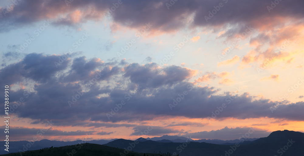 Sunset. Sky clouds background. Ridge Mountains silhouette. Skyline. Montenegro