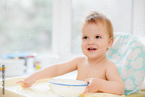 The child in the kitchen ate porridge